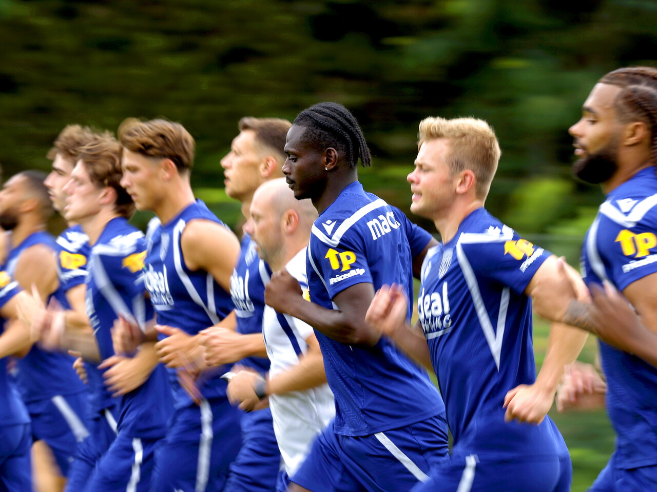 Several WBA players running forward during a training session