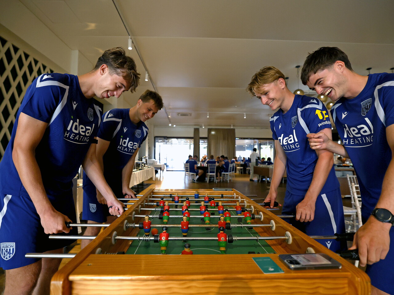 Four WBA players playing table football