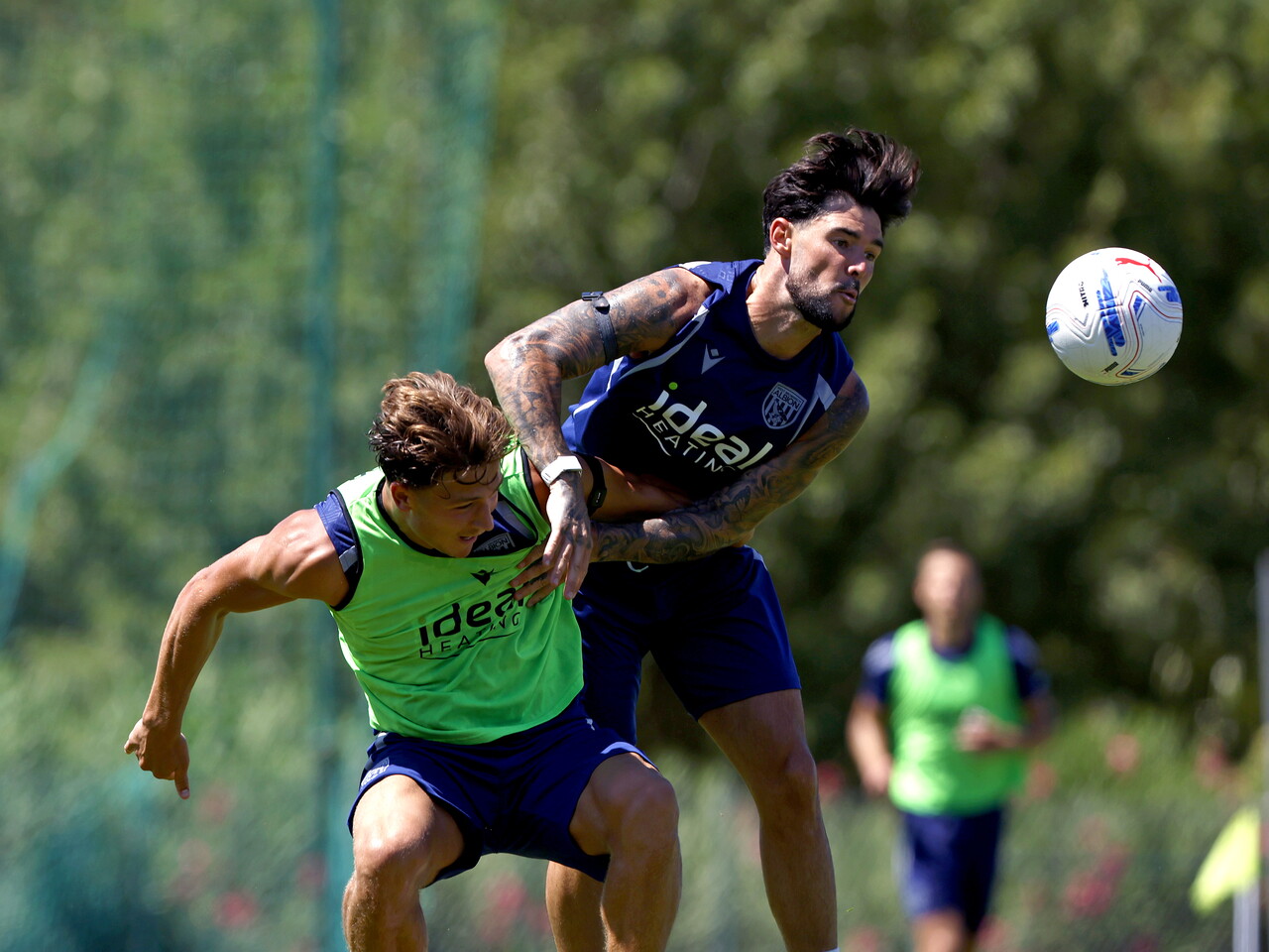 Alex Mowatt and Cole Deeming battling for the ball during a training session