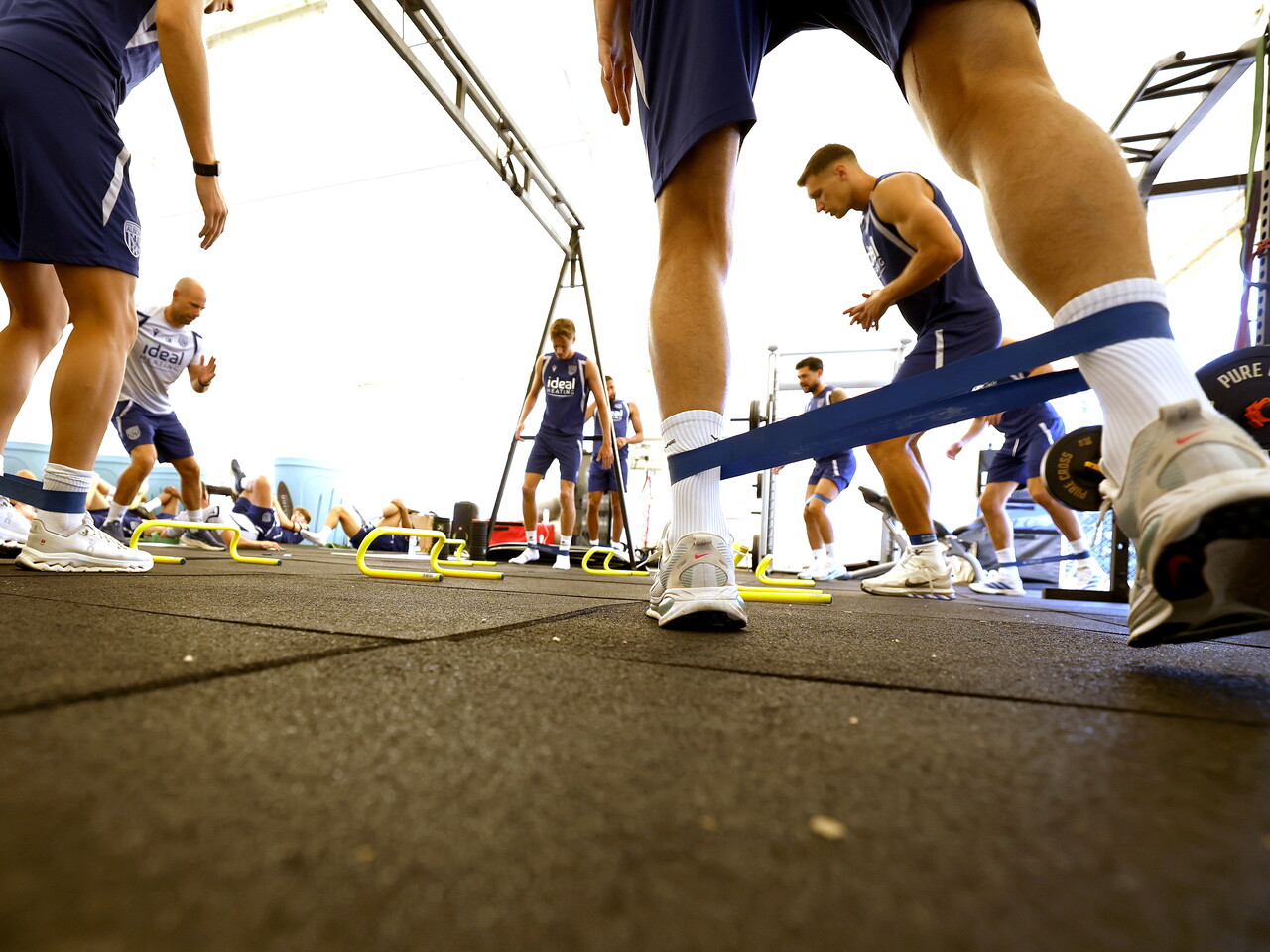 Several WBA players using stretching bands in the gym