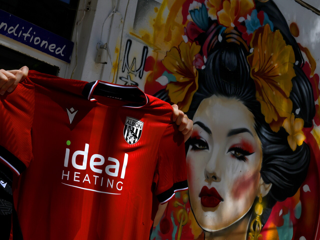 A WBA away shirt is held up out in Portugal