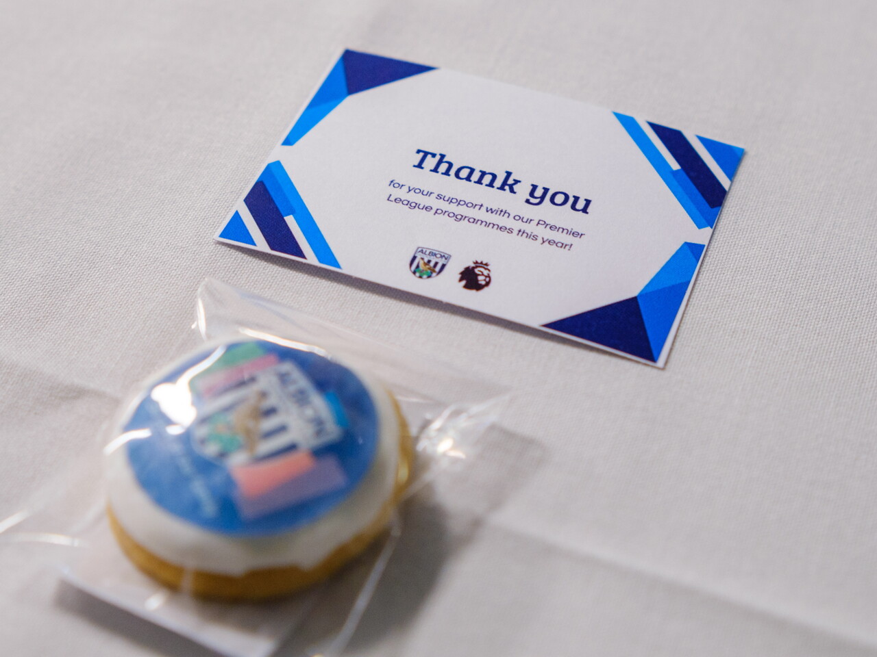 Close-up of Thank You card and Albion Foundation themed biscuit.