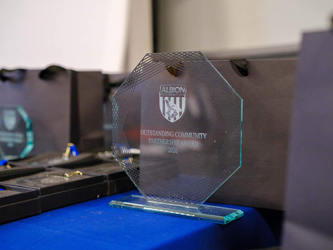 Close-up of Outstanding Community Partnership glass award on the table