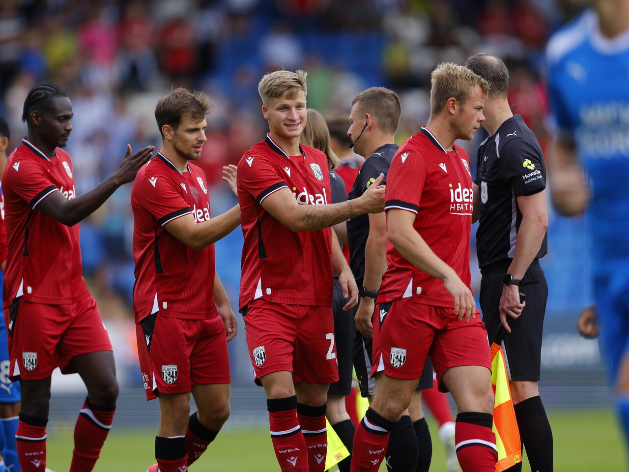Albion players shaking hands with the officials before the Peterborough game