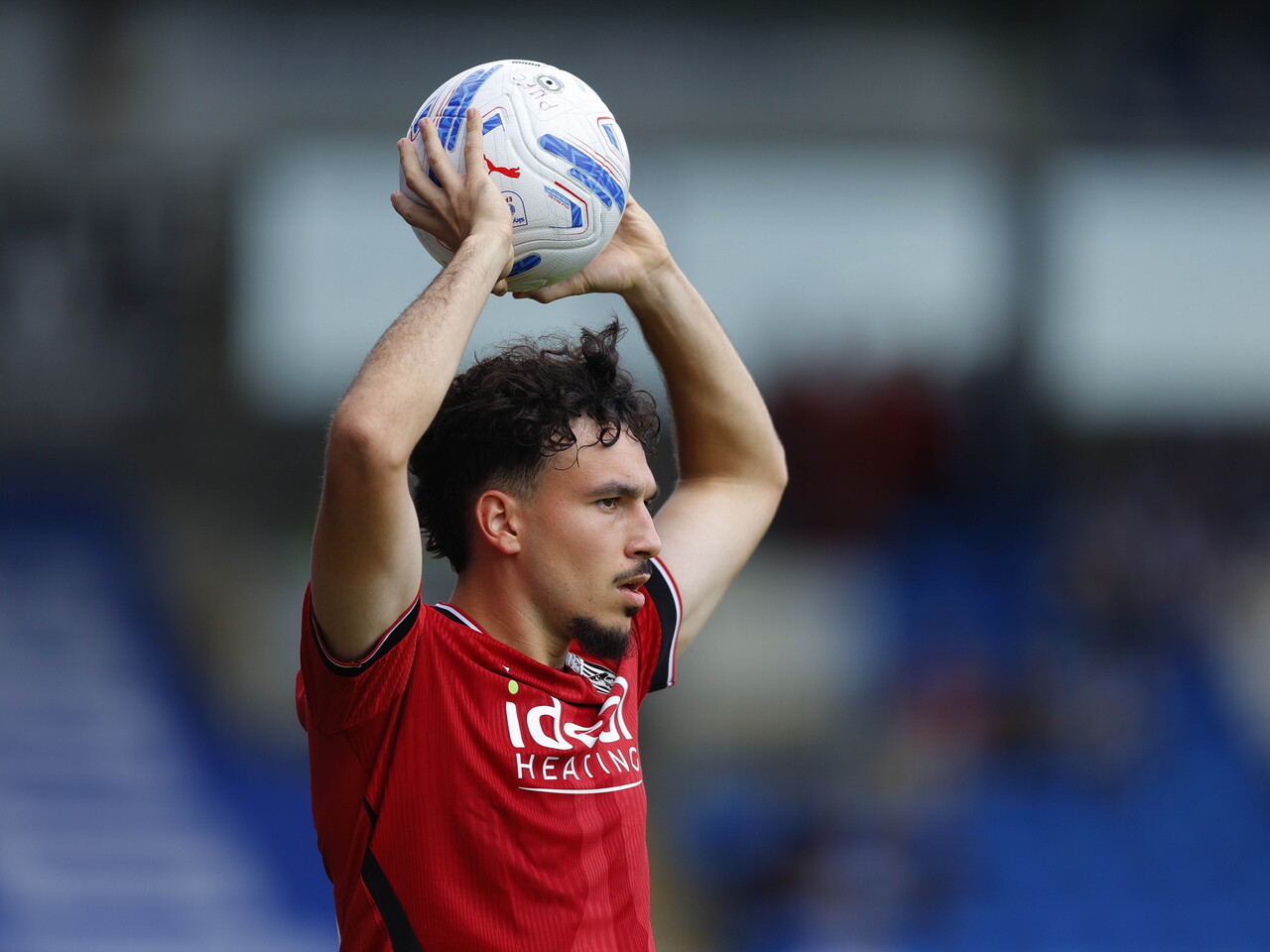 Nolan Galves with the ball above his head about to take a throw in against Peterborough 