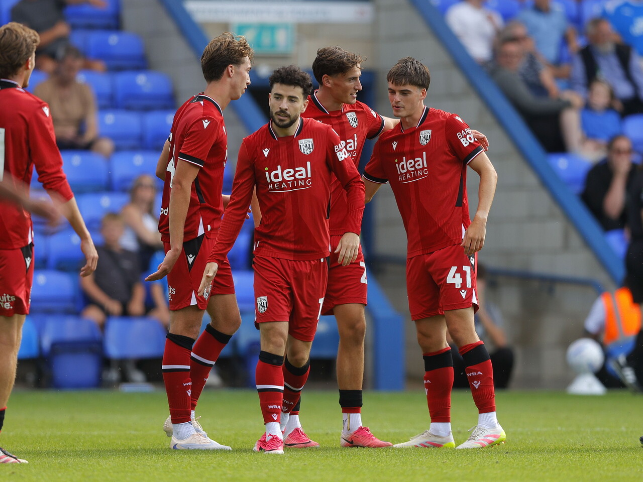 Barney Stewart celebrating with team-mates after scoring at Peterborough