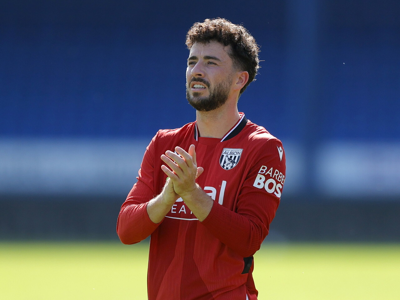 Mikey Johnston applauding WBA fans at Peterborough
