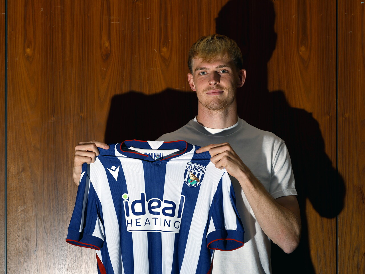 Toby Collyer holding the 26/27 home shirt