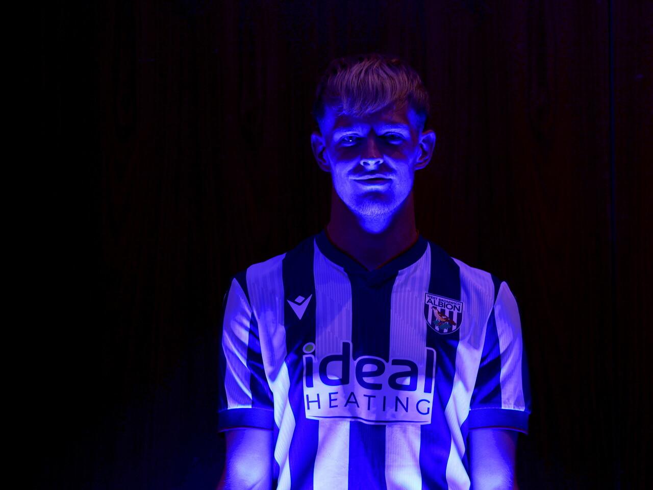 Toby Collyer poses in blue light