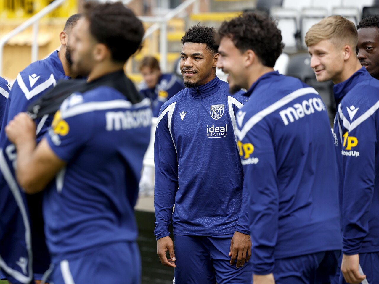 Kareem Tunde laughing with team-mates before a training session