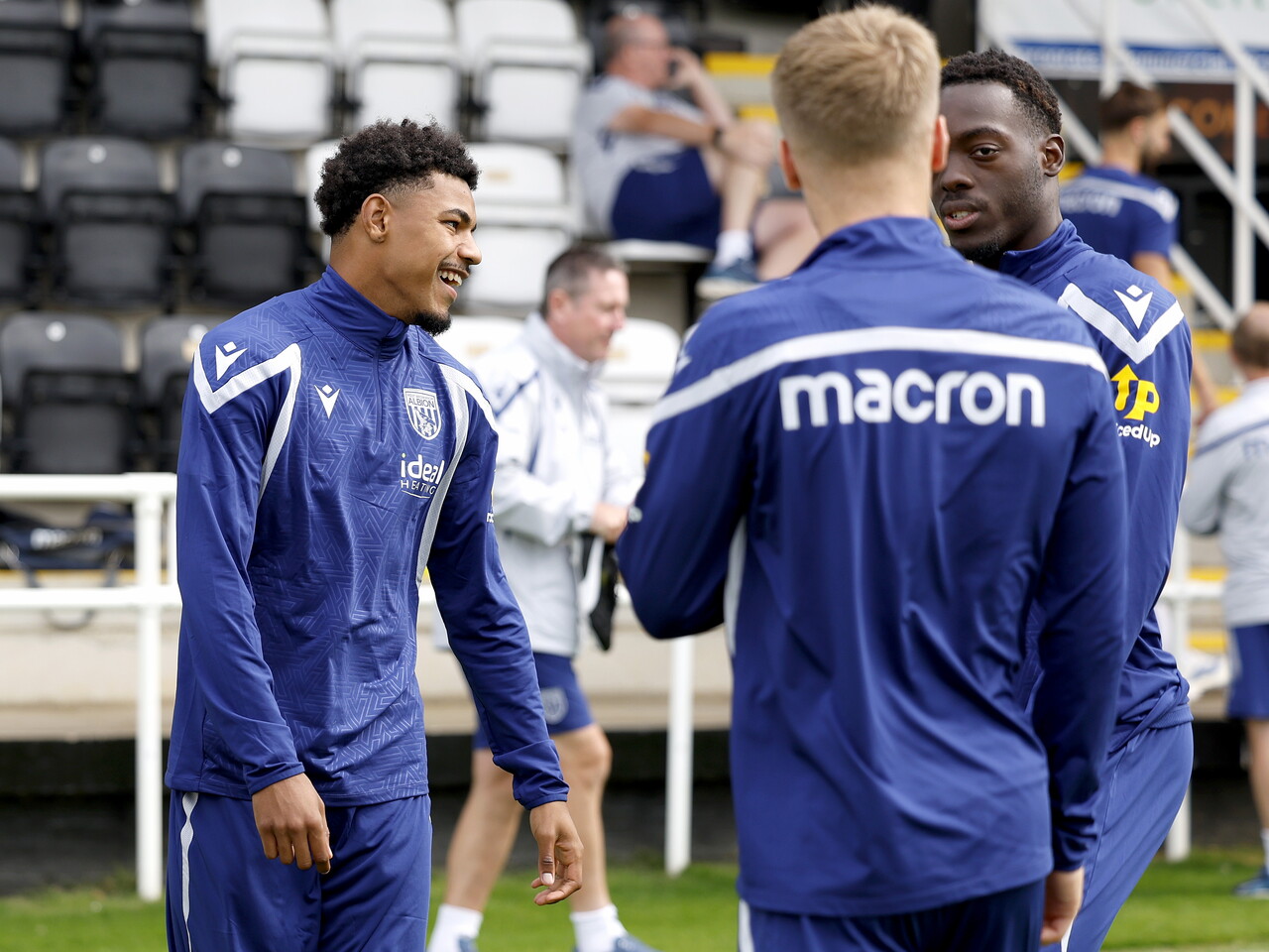 Kareem Tunde laughing with team-mates before a training session