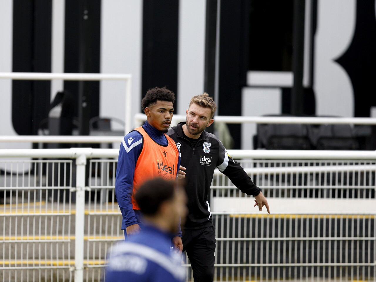 Kareem Tunde talking to James Morrison during a training session