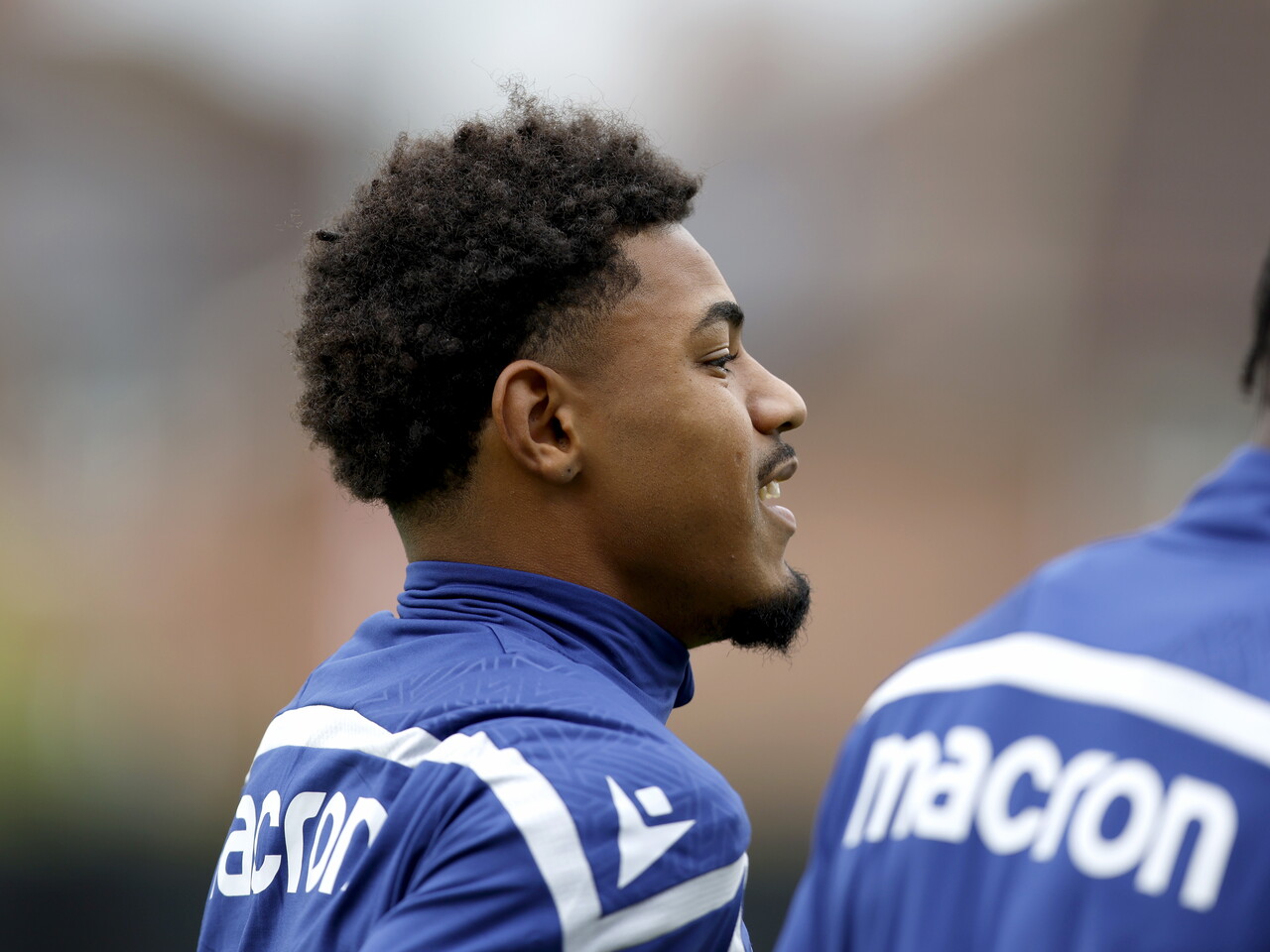 A close up shot of the side of Kareem Tunde's face with him smiling during a training session