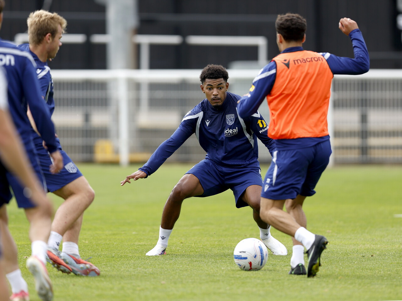 Kareem Tunde defending with a player running at him during a training session
