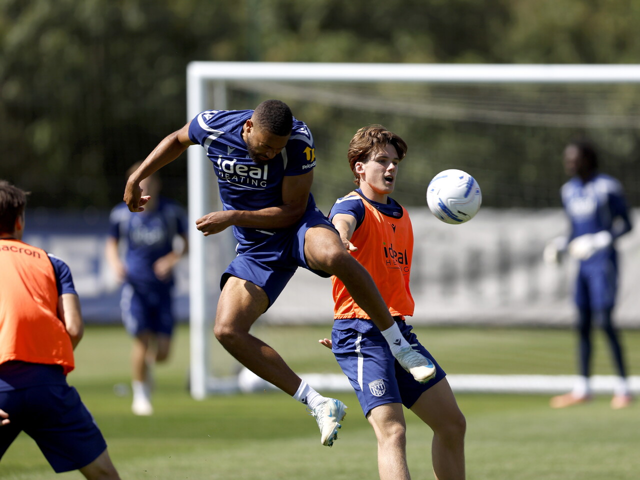 George Campbell jumping to win a header during a training session