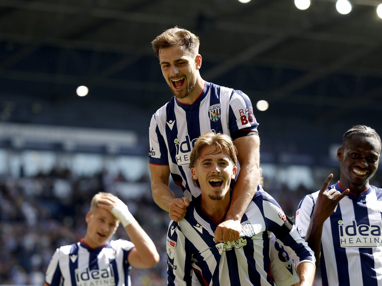 Isaac Price and Jayson Molumby celebrate the penalty goal