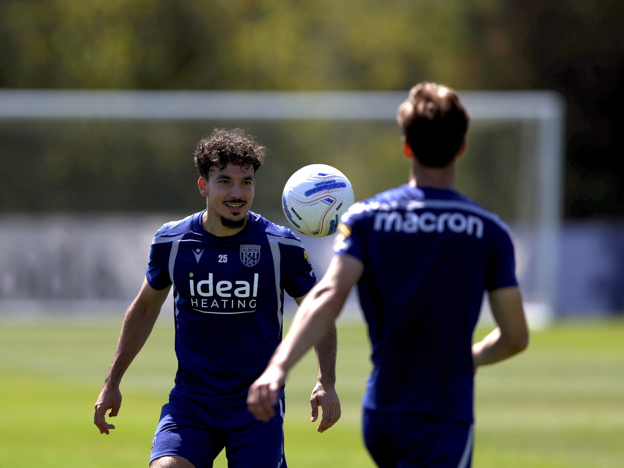 Nolan Galves smiling during a training session while watching the ball in mid-air 