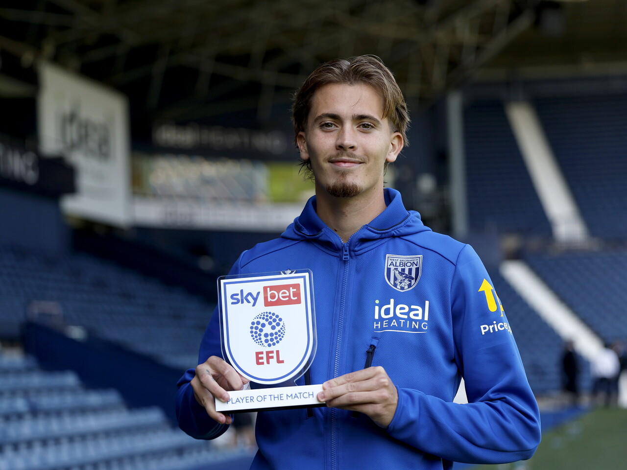 Isaac Price holds his Player of the Match trophy