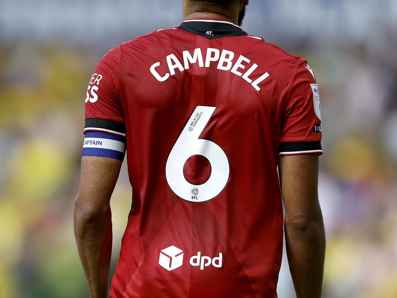 The back of George Campbell's shirt and the captain's armband