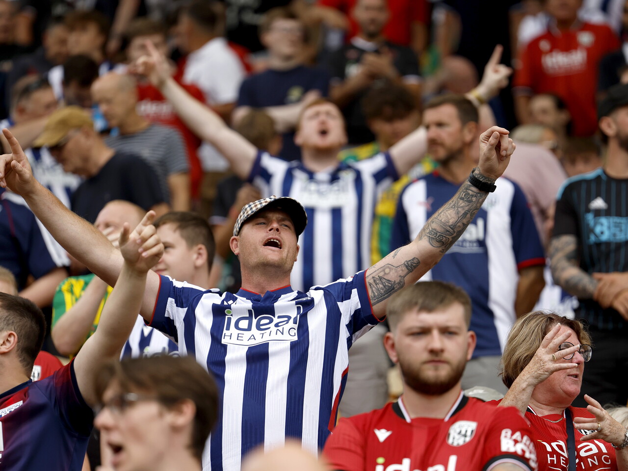 Albion fans celebrate at full-time.