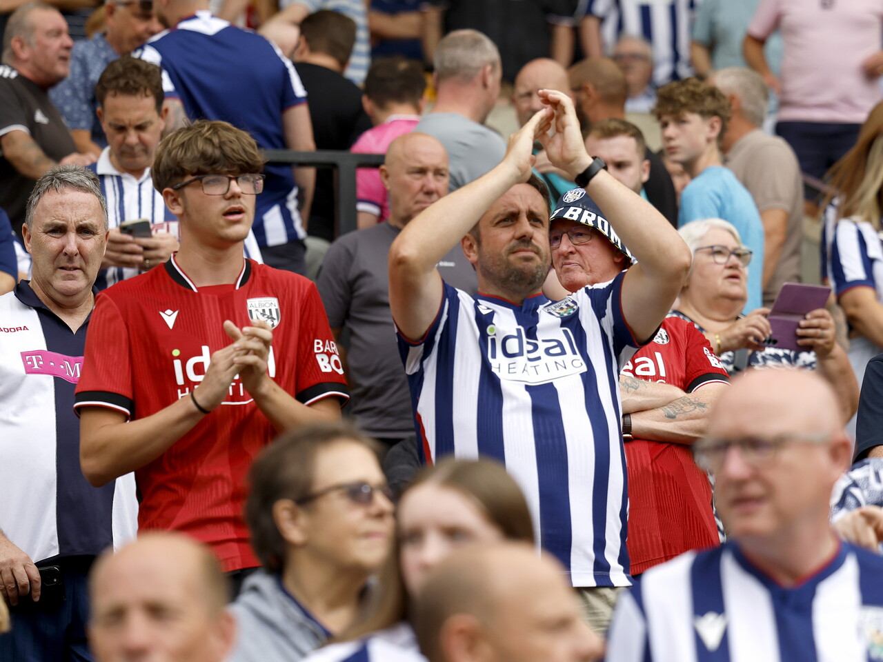 Albion fans celebrate at full-time.