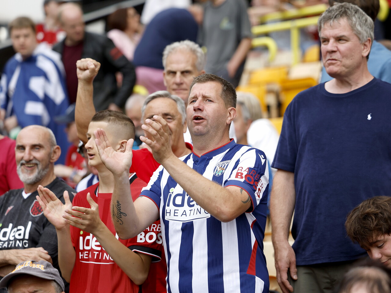 Albion fans celebrate at full-time.