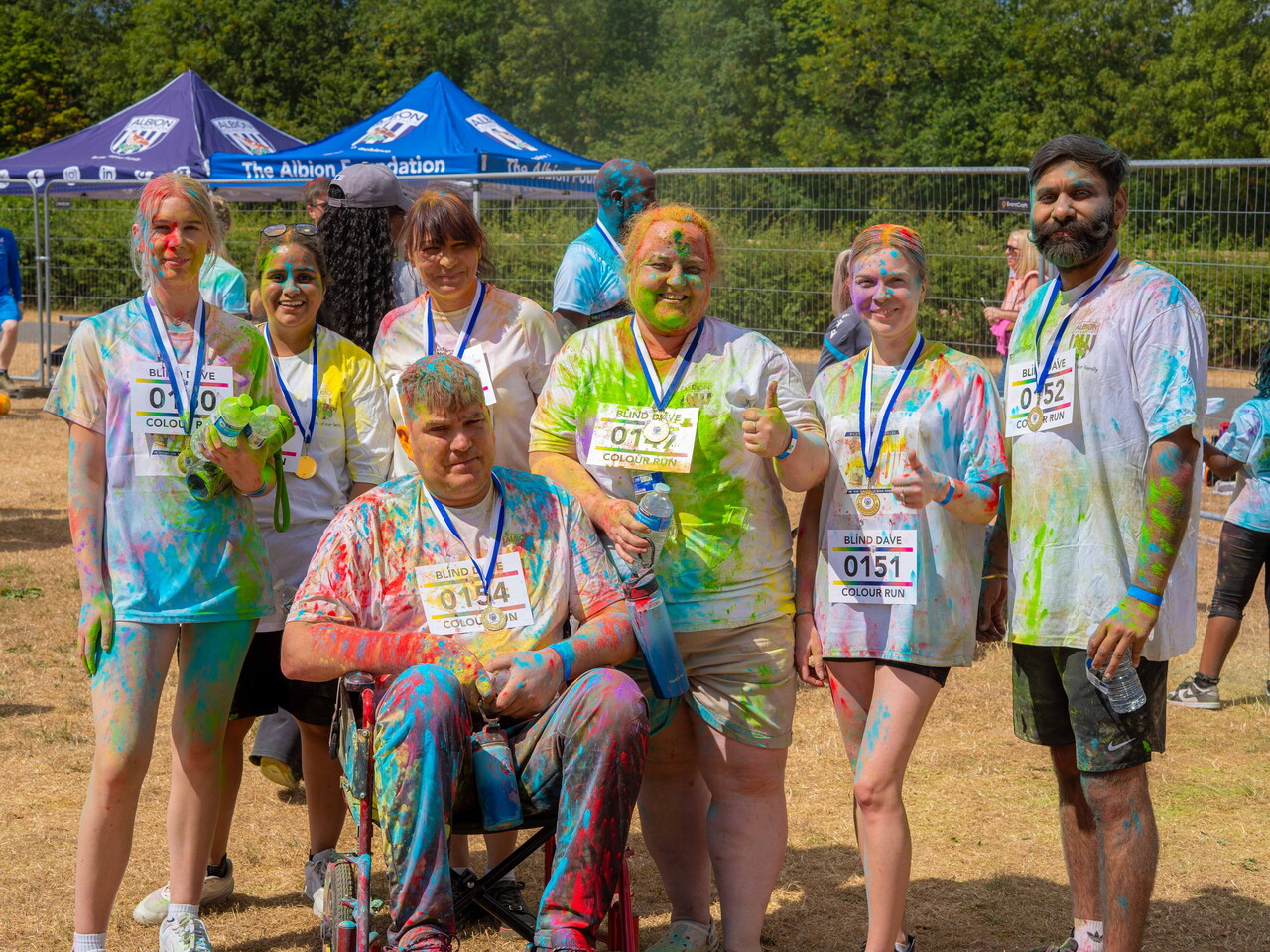 Group of colour run participants posing together after the event.