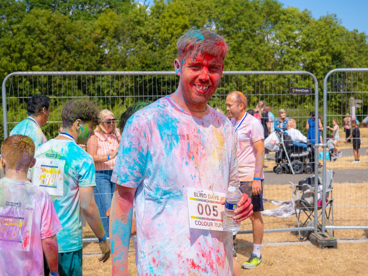 Participant posing for a photo covered in paint.