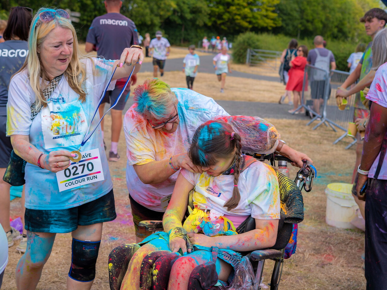 Group gathered around a wheelchair user after the event.