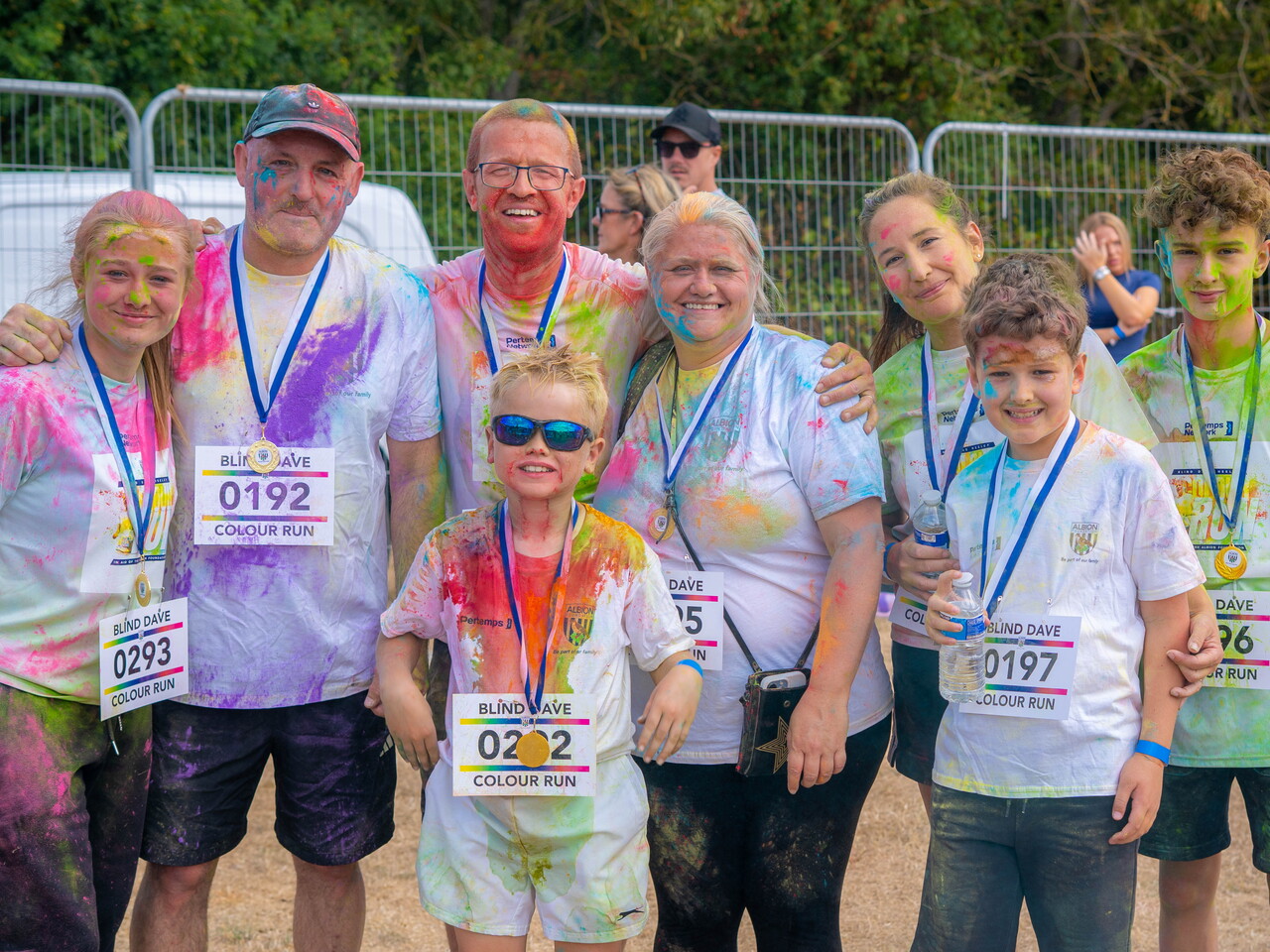Group of participants posing with finisher medals.