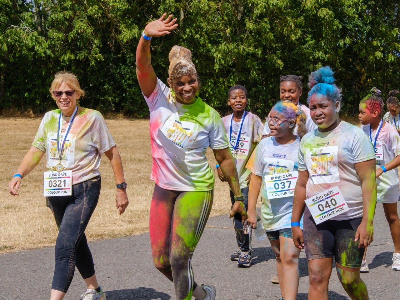 Group of participants approaching the finishing area waving.