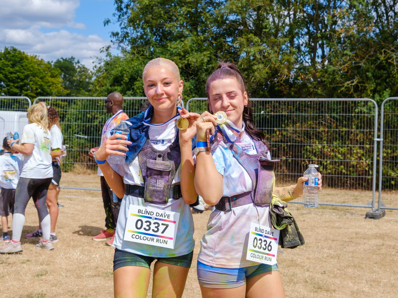 Two participants posing with finisher medals.