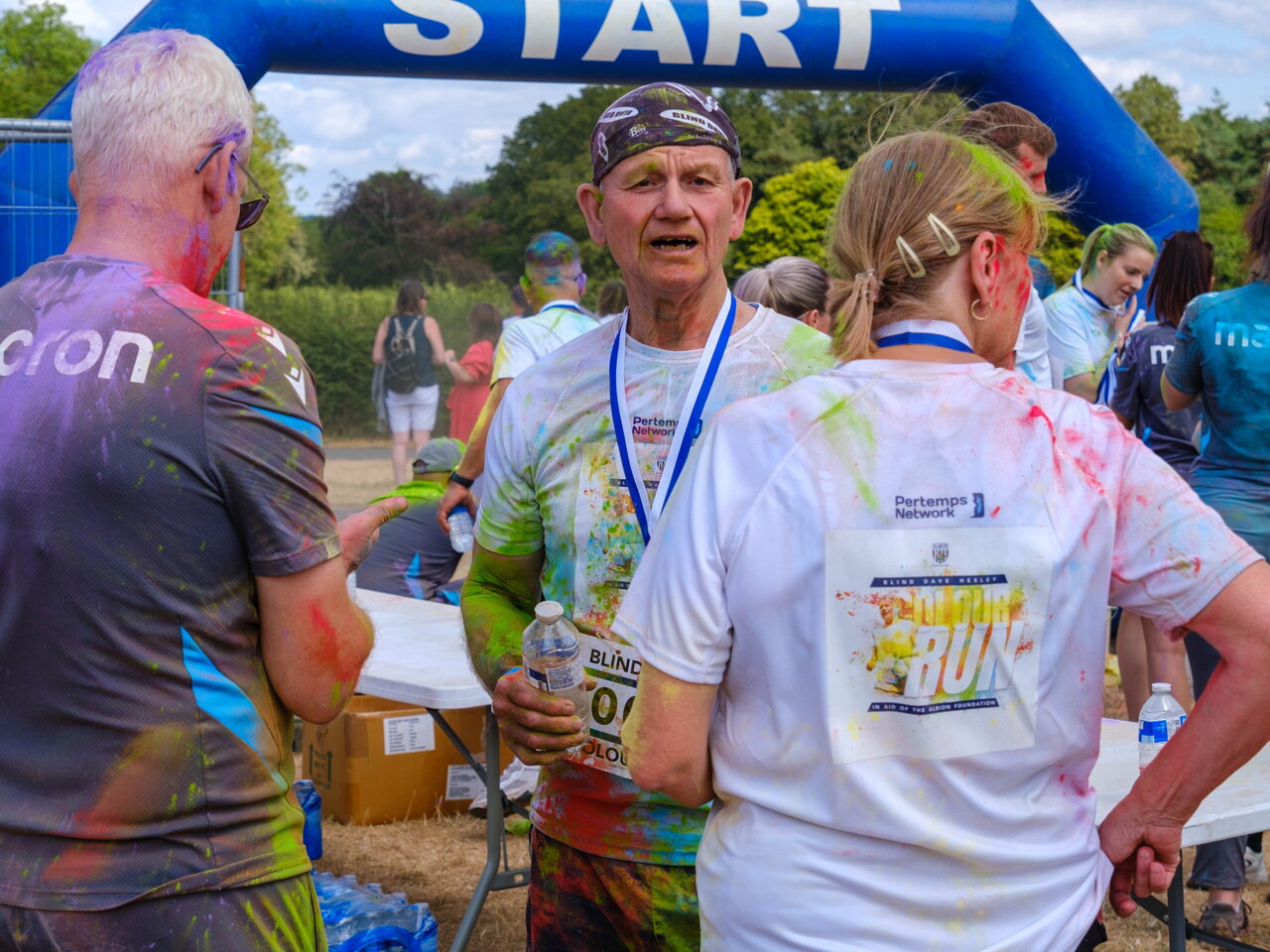 Participants gathering near the FINISH arch after finishing.