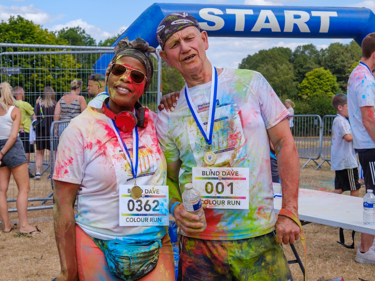 Blind Dave and participant posing for a photo after the Colour Run.