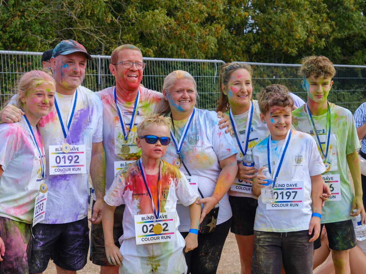 Group of participants posing with medals.