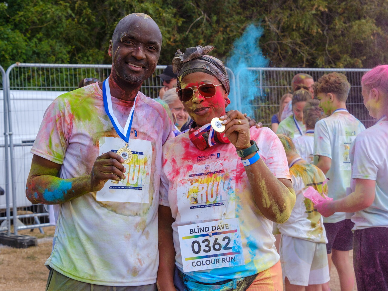 Participants posing for a photo holding medals after the Colour Run.