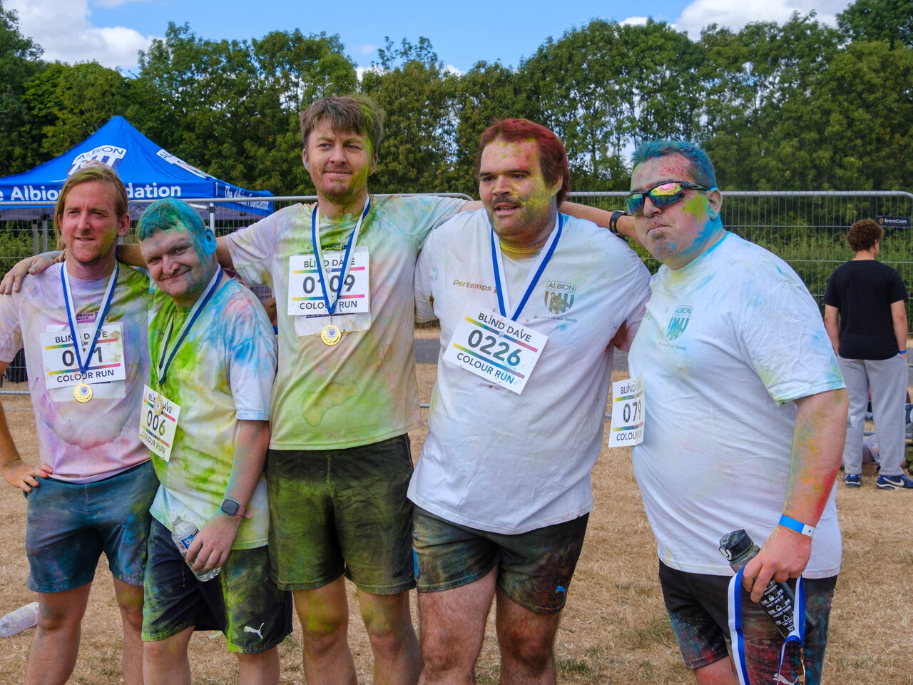 Group of participants posing with medals.