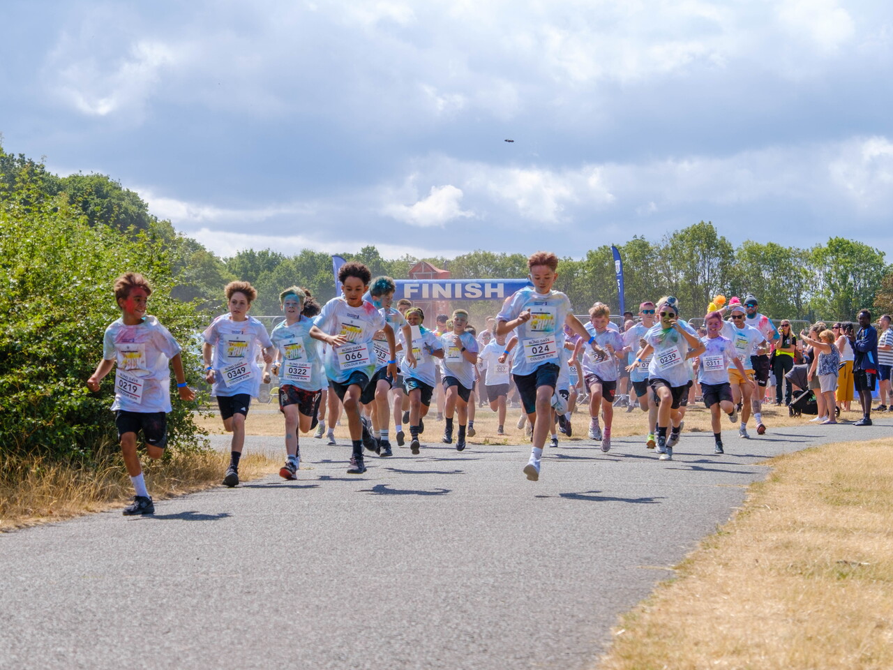 A large group of participants runs together along the event route.