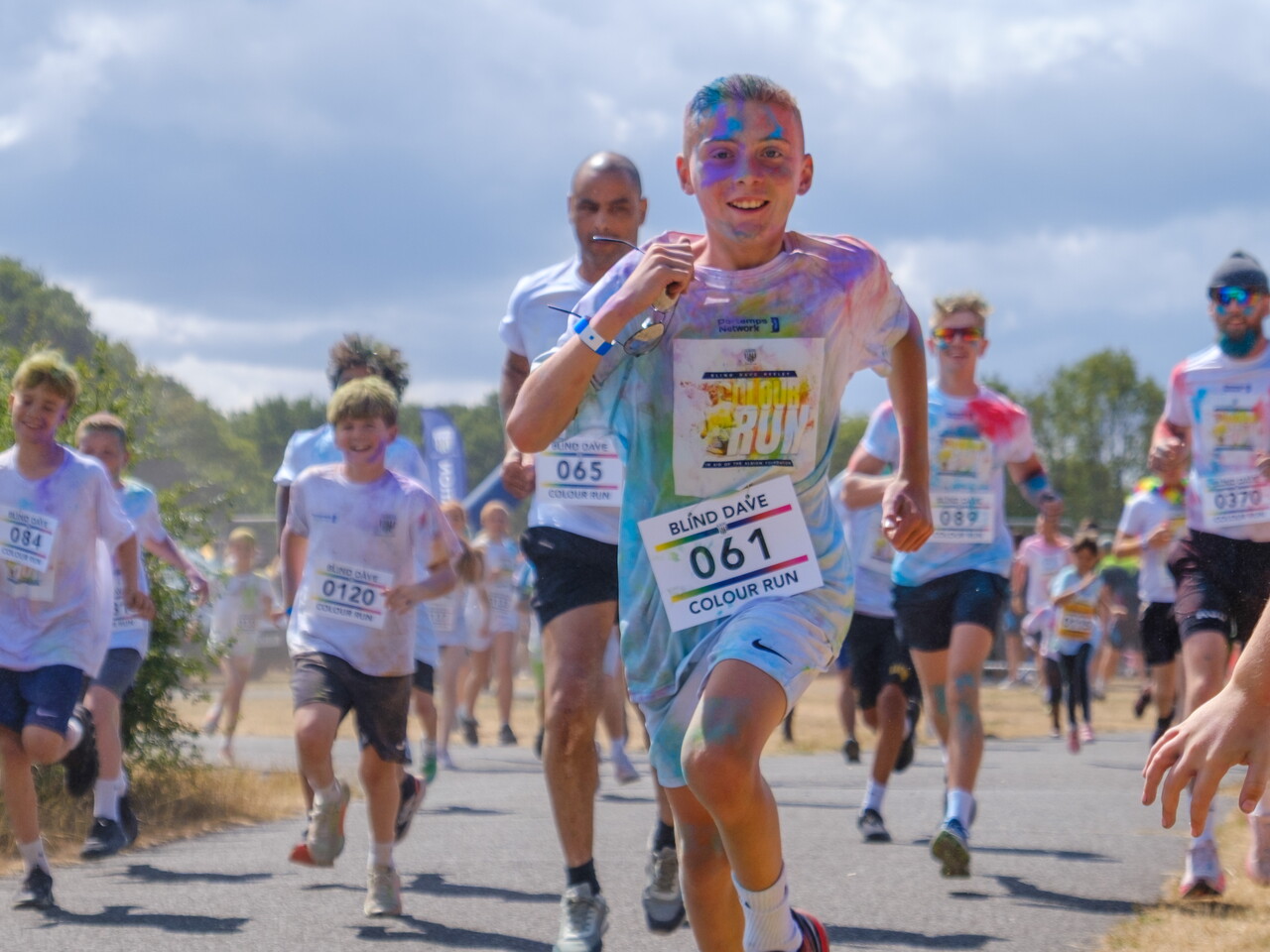 Participants run toward the camera during the color run event.
