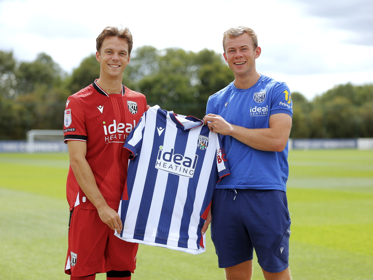 Felix Horn Myhre and Aune Heggebø stood smiling at the camera while holding up a home WBA shirt 