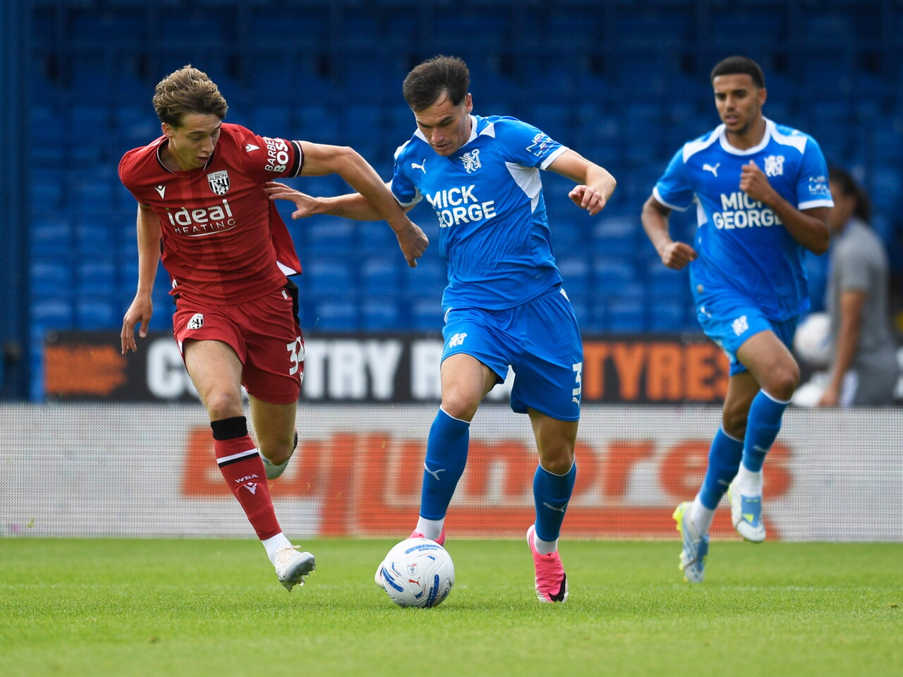 Harry Whitwell battling for the ball with a Peterborough player