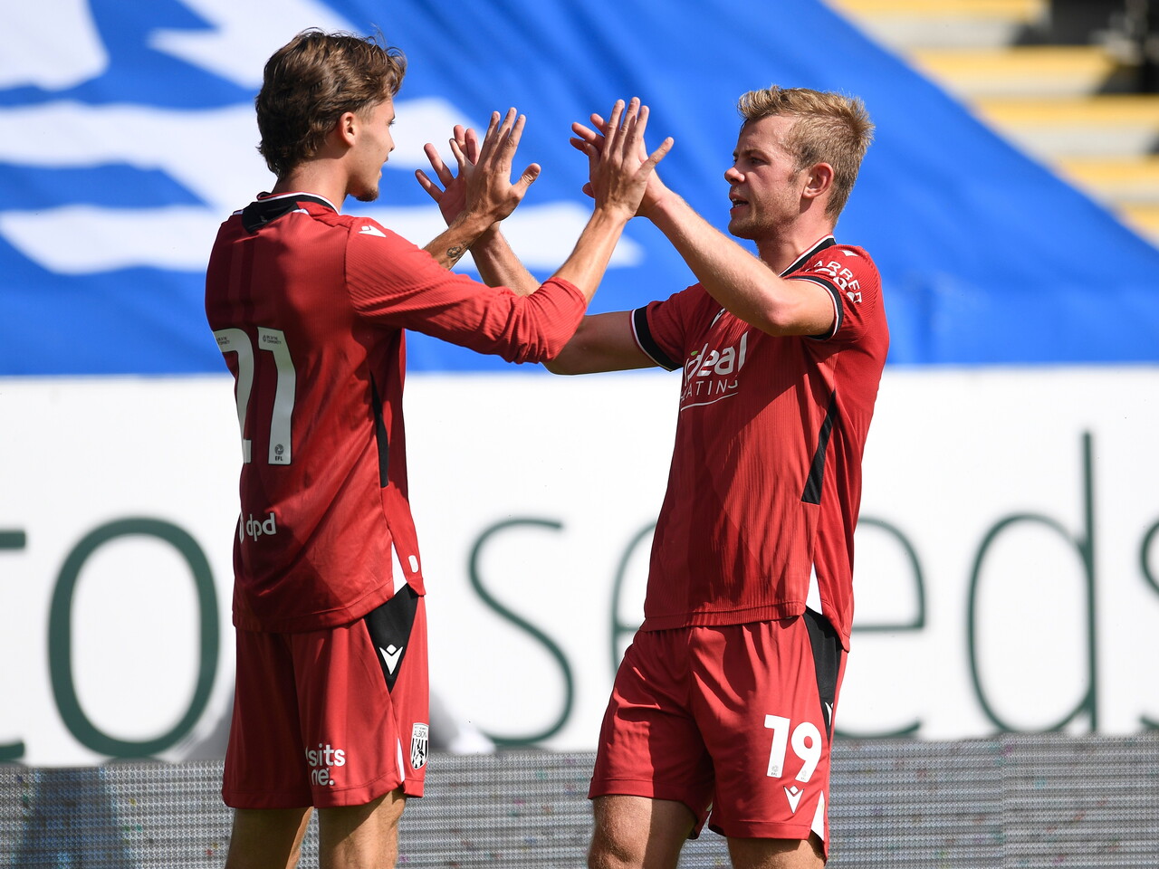 Aune Heggebø and Isaac Price high-fiving after Aune's goal at Peterborough 