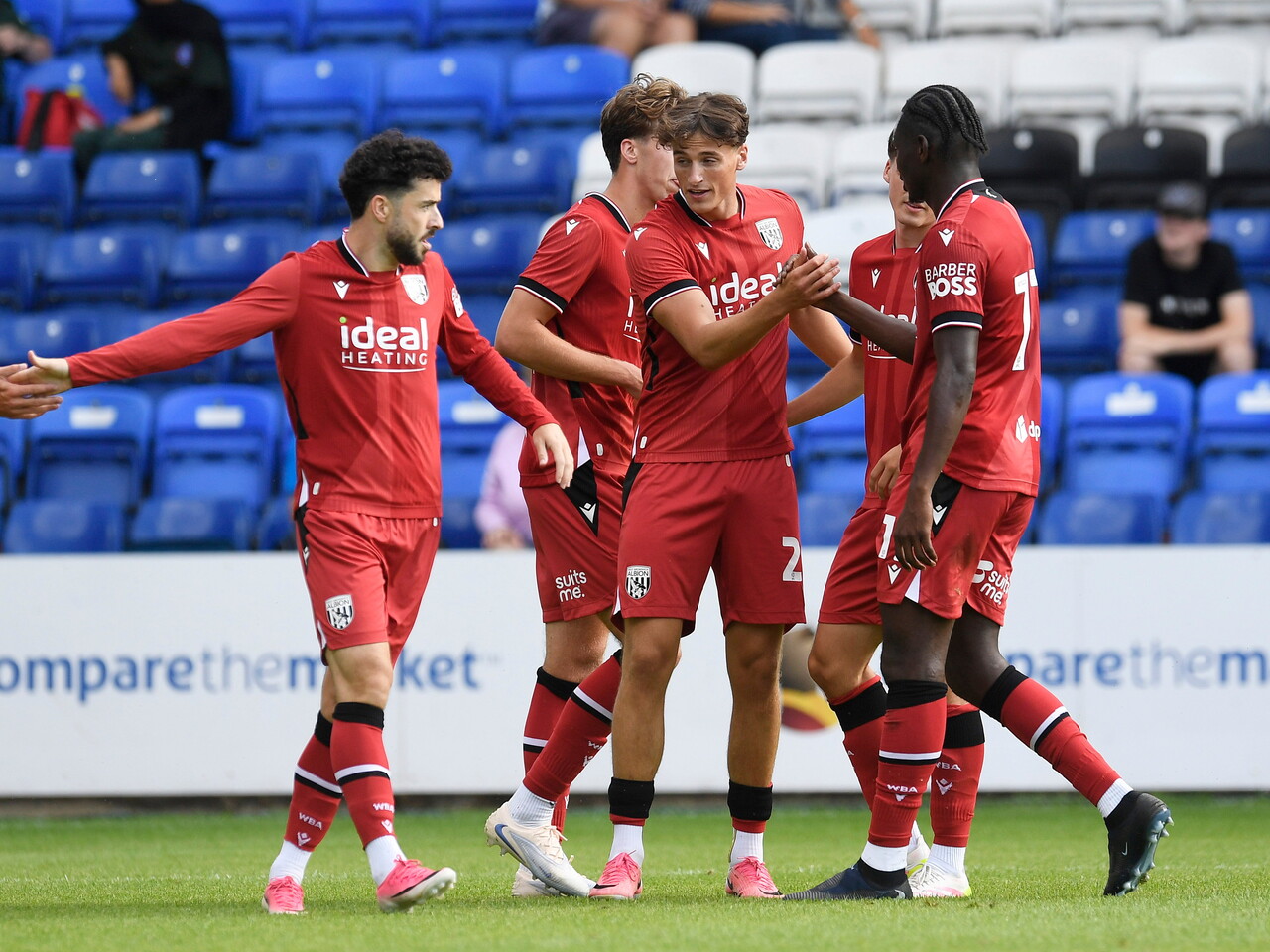 Barney Stewart celebrating with team-mates after scoring at Peterborough