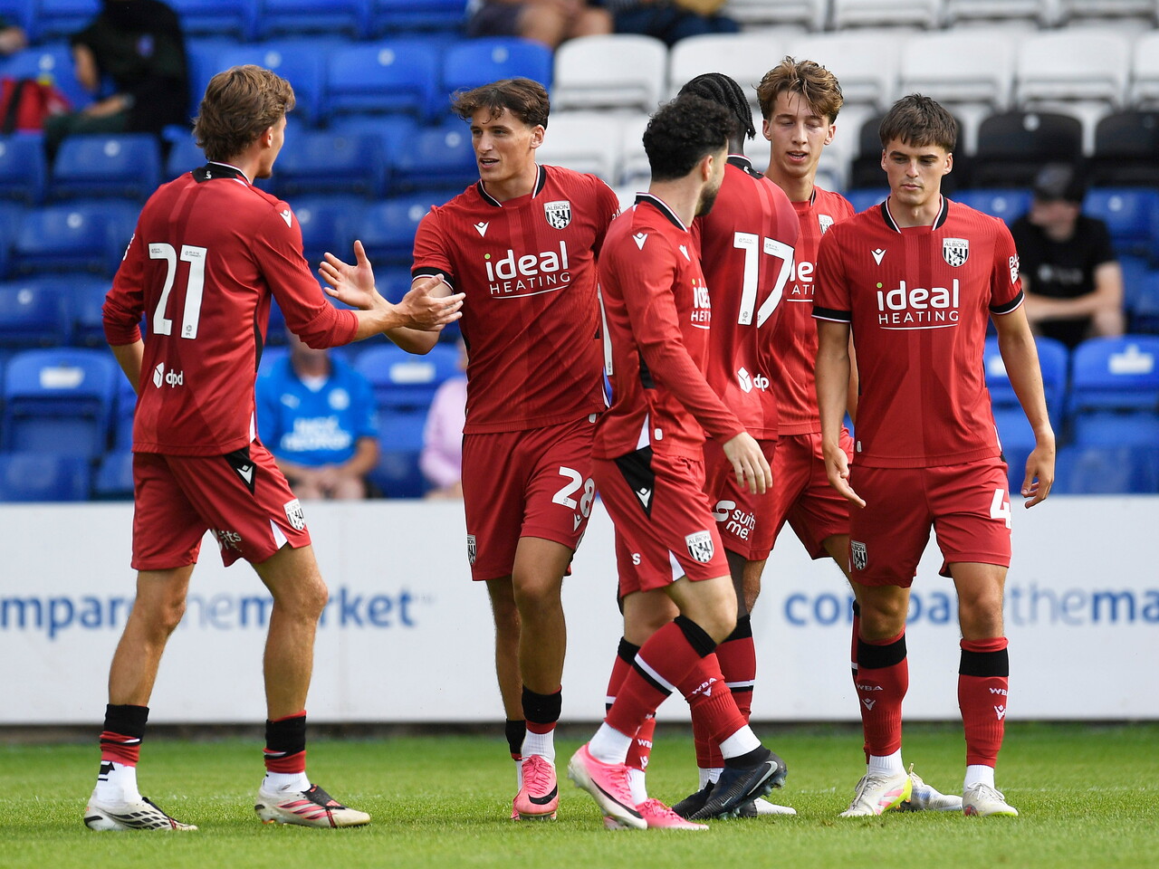 Barney Stewart celebrating with team-mates after scoring at Peterborough