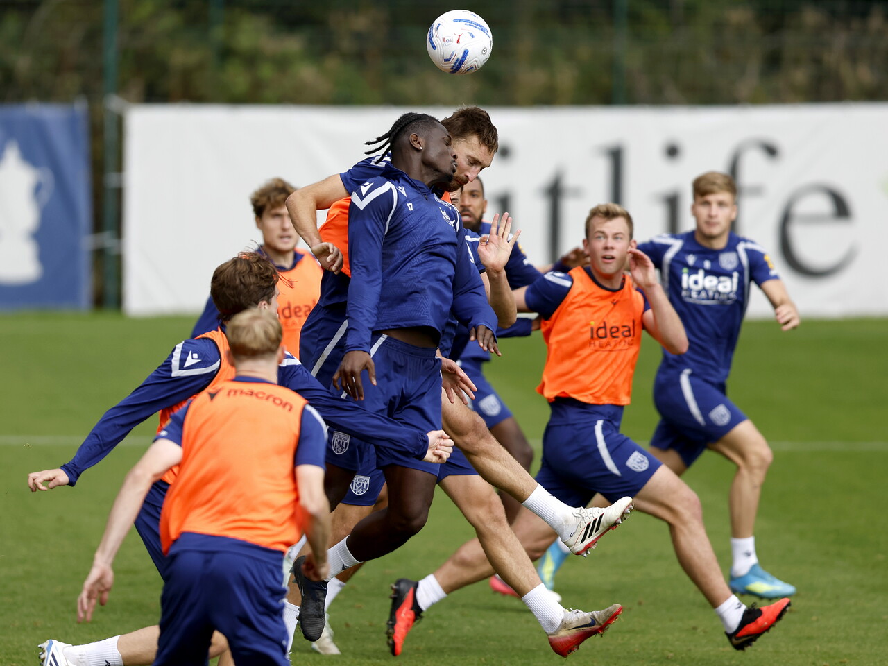 Ousmane Diakité and Nat Phillips jumping to try and win a header during a training session