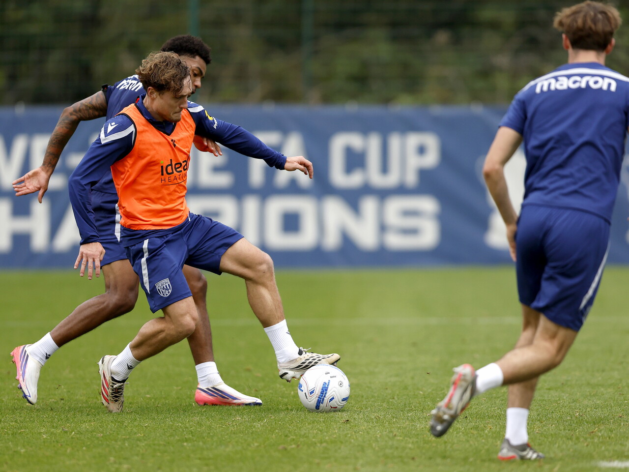 Callum Styles on the ball during a training session, closely followed by Kareem Tunde
