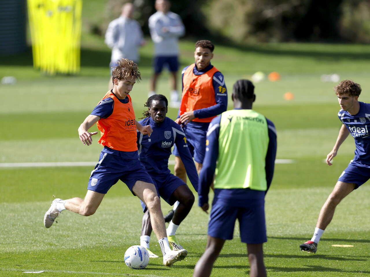 Harry Whitwell on the ball during a training session, closely watched by Brayann Pereira 