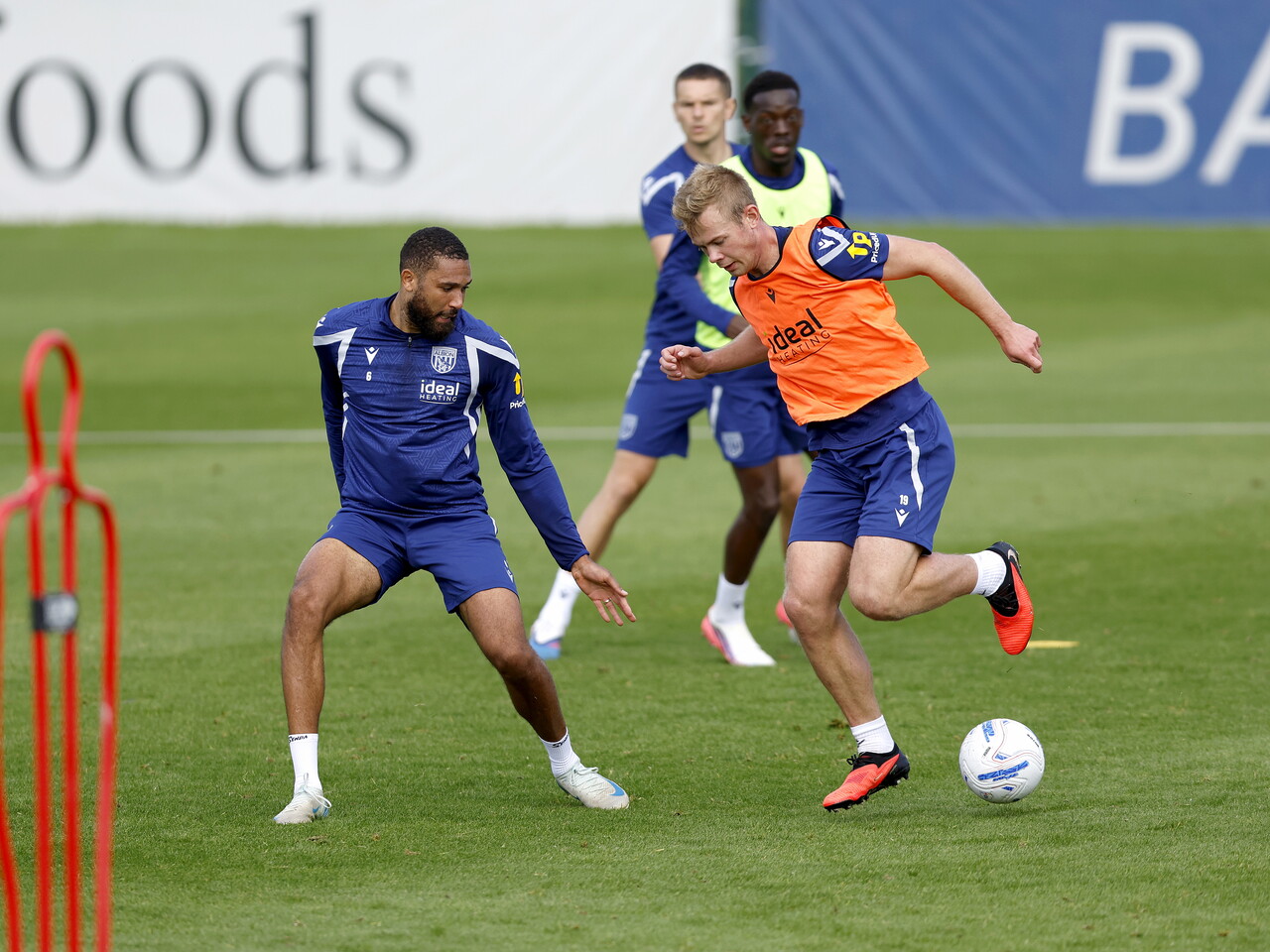 Aune Heggebø on the ball during a training session, closely watched by George Campbell
