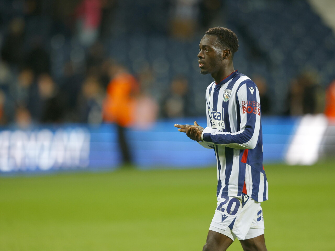 Rabby Nzingoula applauding WBA fans after the full-time whistle against Charlton