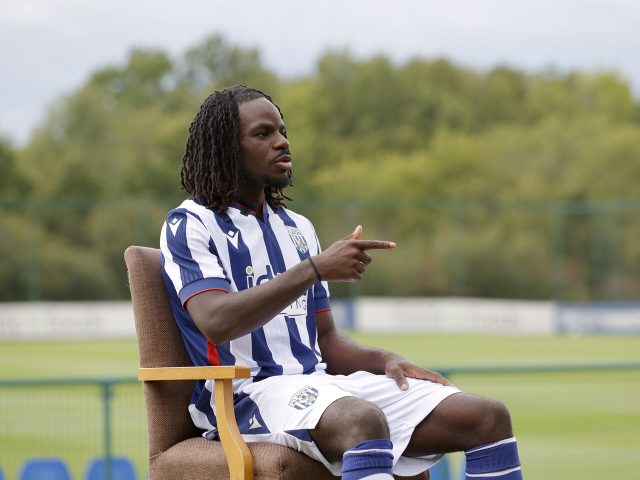 Brayann Pereira sat in a chair in the home kit while being interviewed by WBA TV